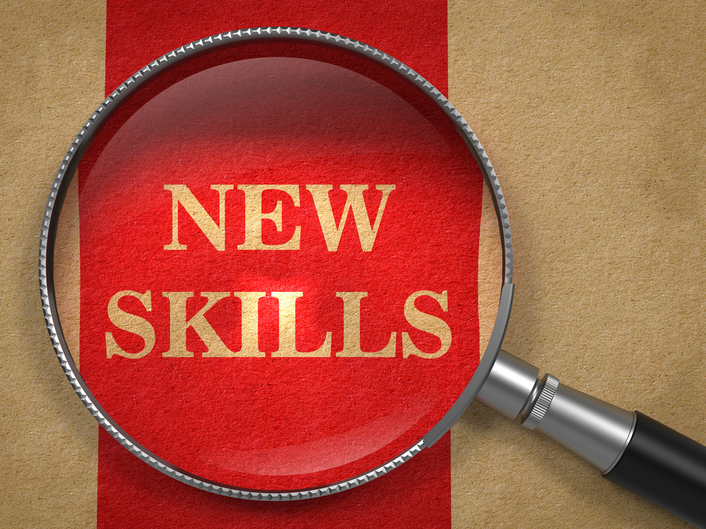 New Skills concept. Magnifying Glass on Old Paper with Red Vertical Line Background.